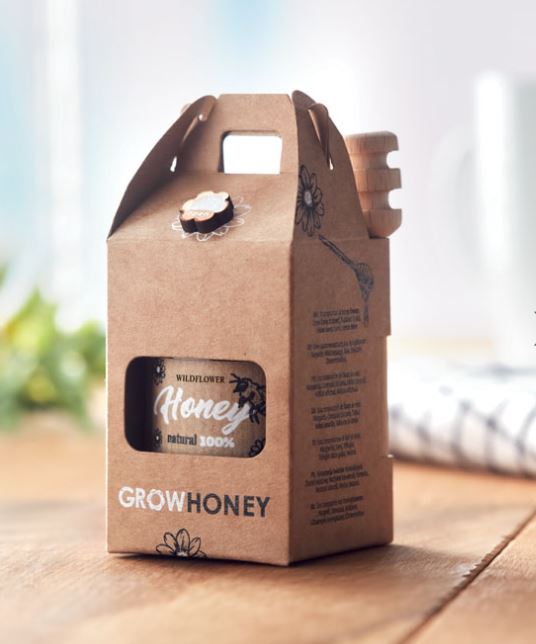 Wildflower honey jar with a wooden dipper, and flower seeds